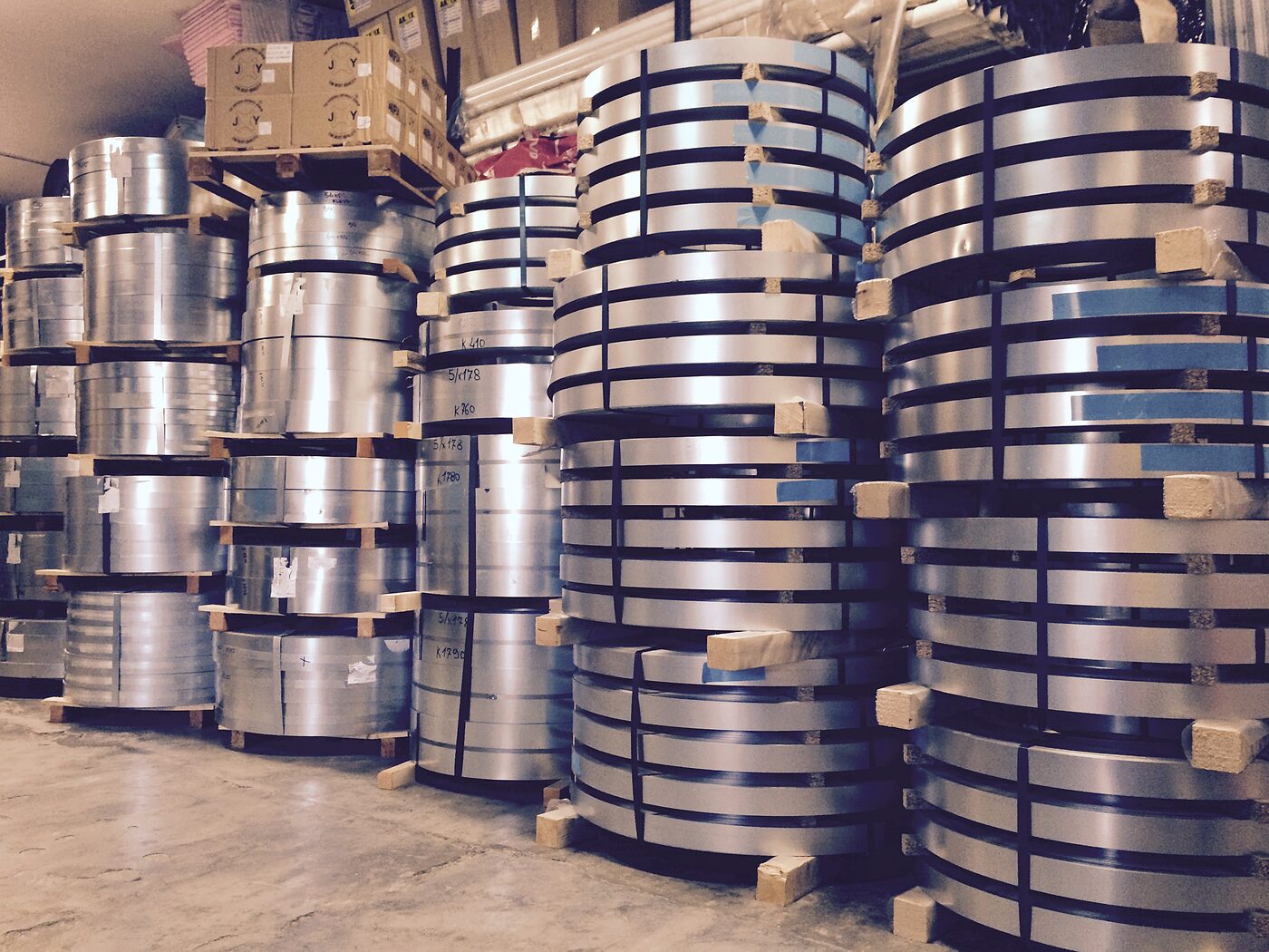 Coils of sheet metal stacked in the factory warehouse