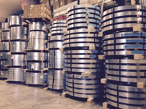 Coils of sheet metal stacked in the warehouse