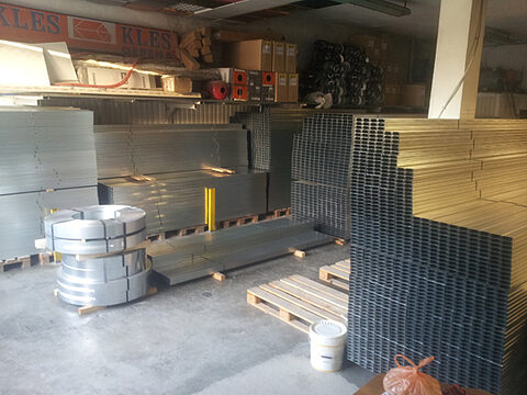 Sheet metal and profiles stored in the industrial hall
