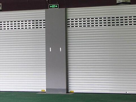 White solid and perforated rolling shutters in a showroom