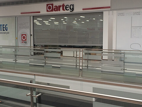 Rolling shutter closed behind a glass balustrade on the upper floor